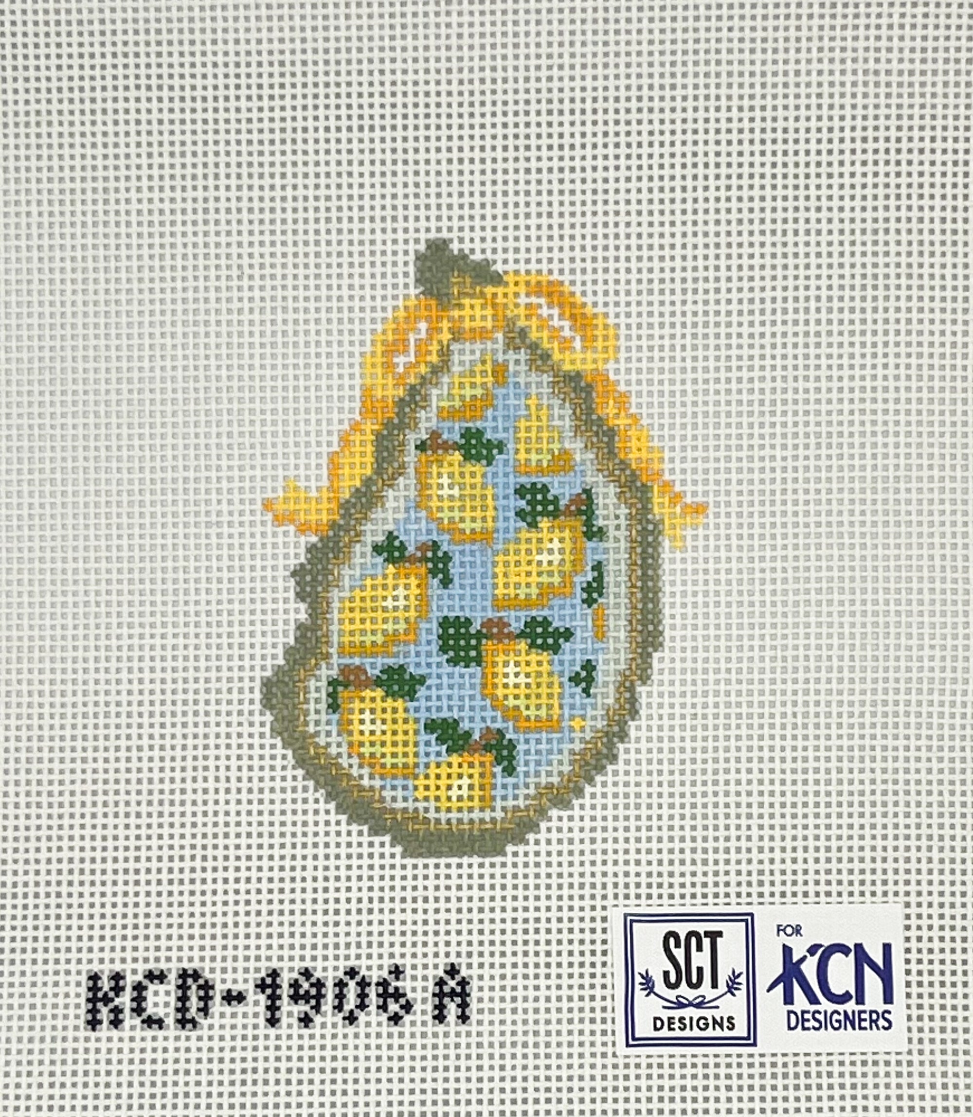 Blue needlepoint oyster with yellow lemons and a yellow bow on a white canvas