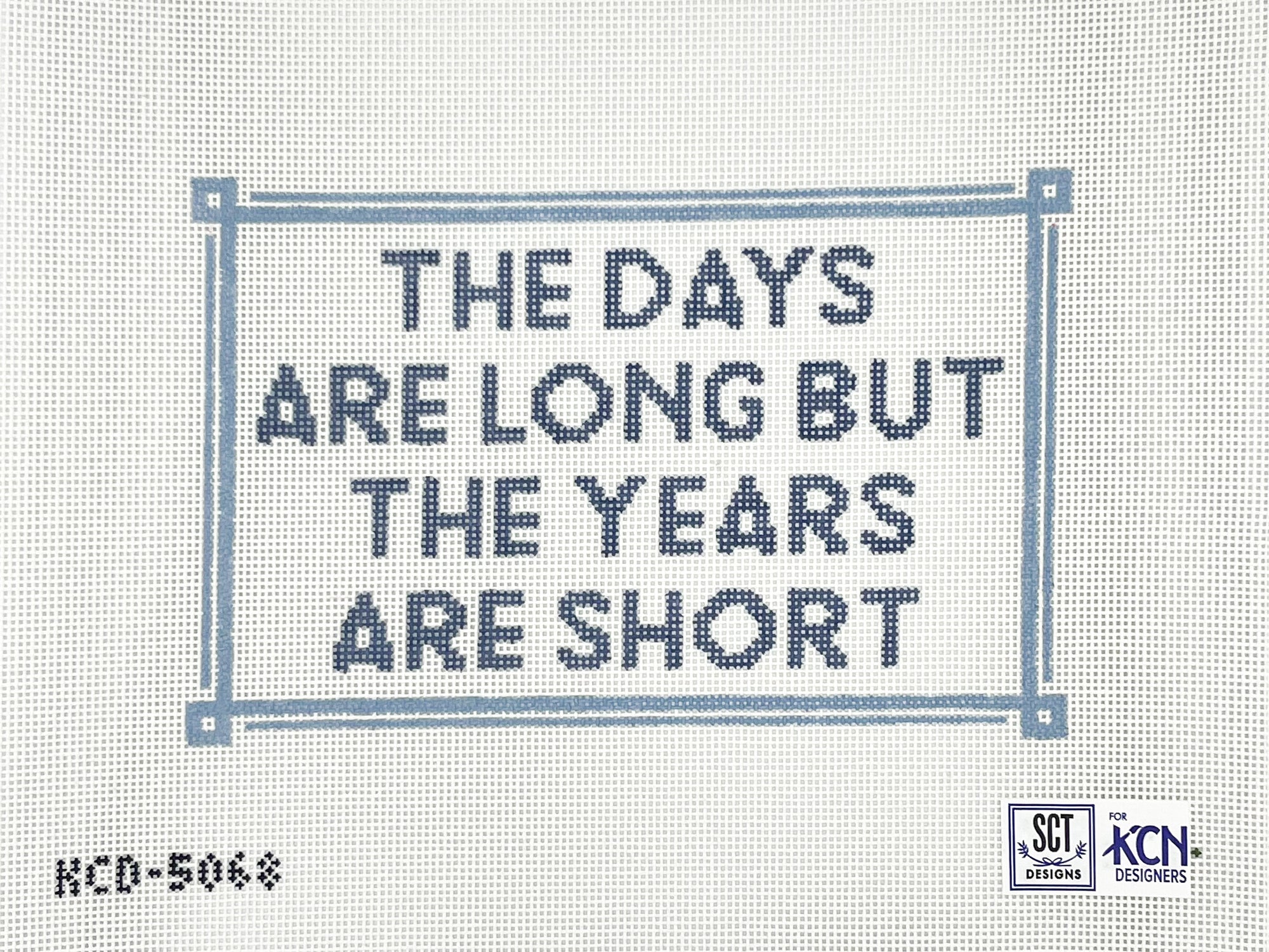 Blue text on a needlepoint canvas that says the days are long but the years are short
