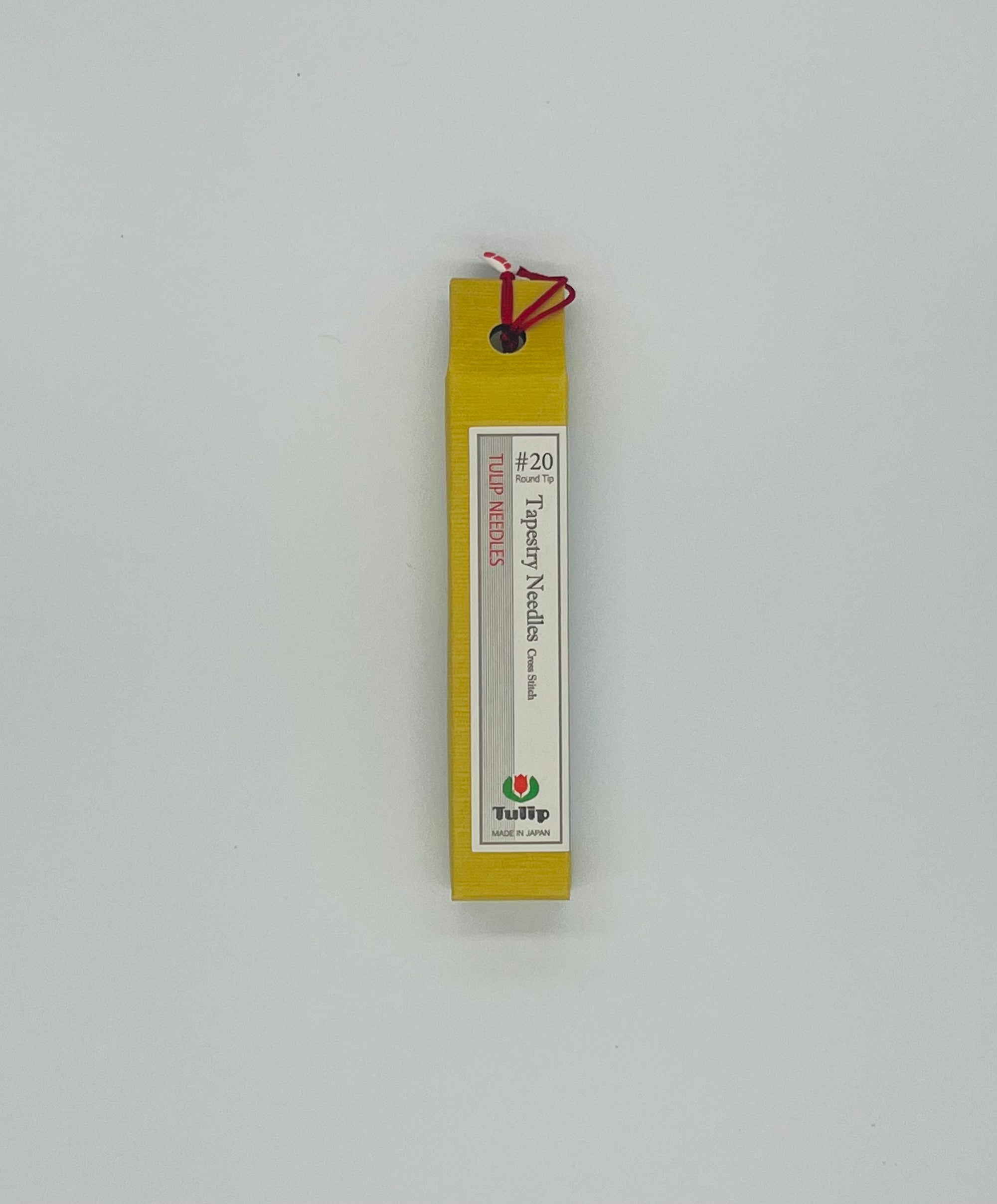 Box that is yellow for tapestry needles #20 with a light gray backdrop