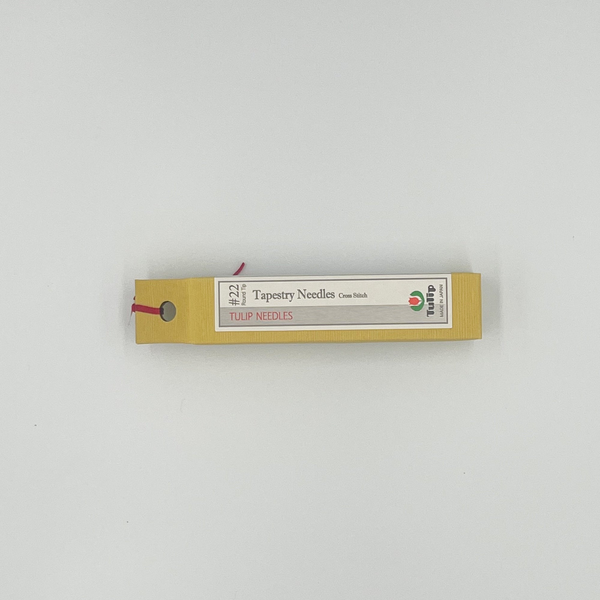 Yellow box that says tapestry needles #22 on a white background