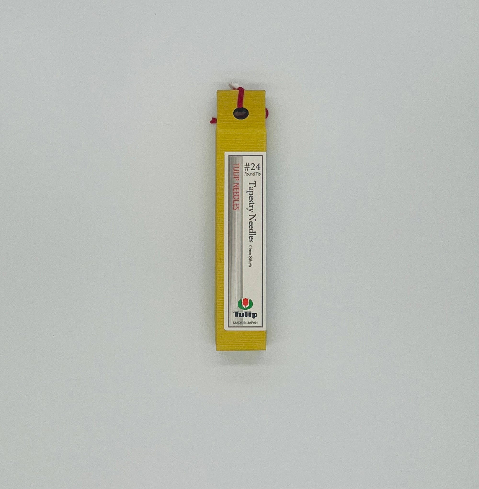 Bright yellow box that reads tapestry needles #24 on a gray background