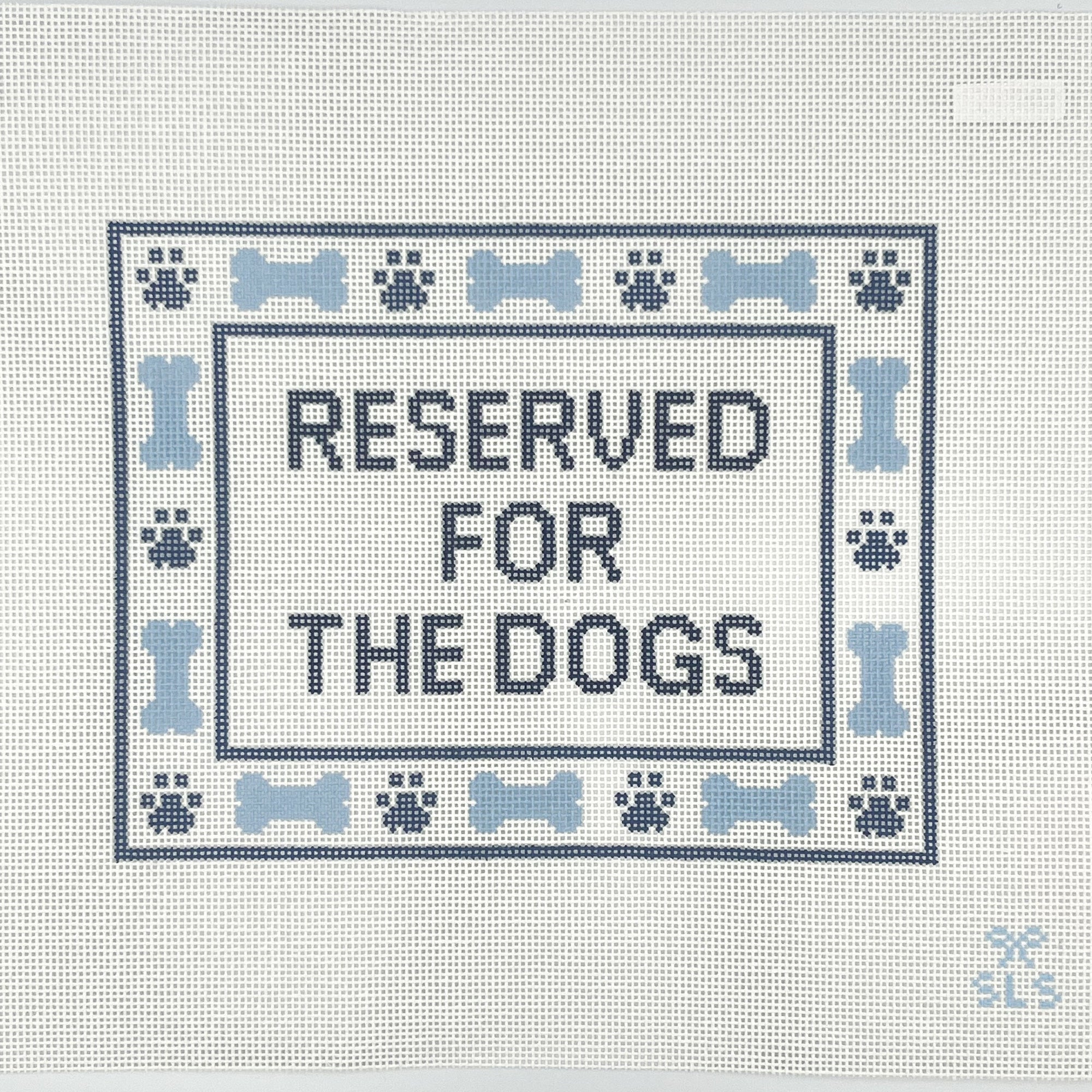 Needlepoint design with 'Reserved for the Dogs' text on a white canvas