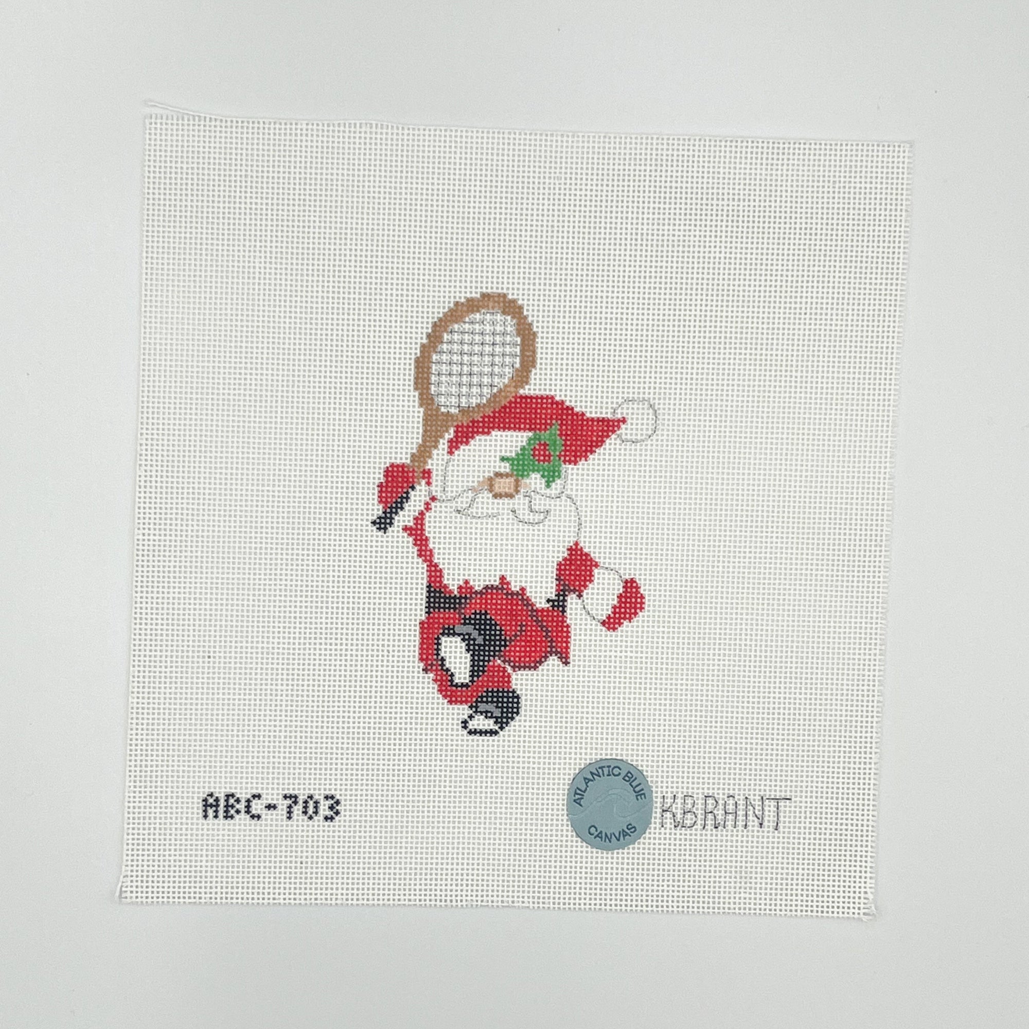 Needlepoint design featuring santa holding a tennis racket on a white canvas